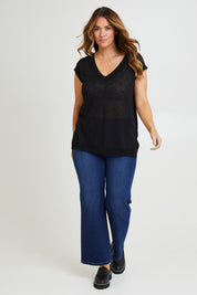 Model Laura wearing size L of the Go To Knit Tank in colour Black (Black), from the front, showing the whole outfit