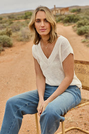 Model Tegan wearing size S of the Go To Knit Tank in colour White (White), from the front, showing the whole outfit