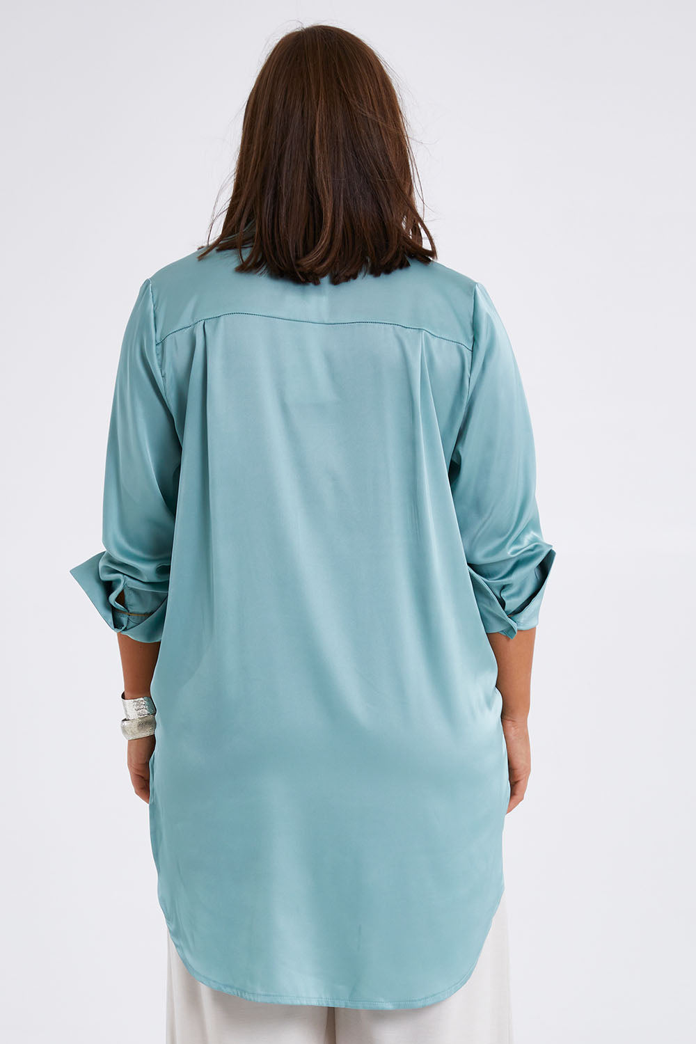 Model Monique wearing size 14 of the Going With The Flow Tunic Blouse in colour Sage (Green), from the back