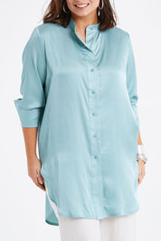 Model Monique wearing size 14 of the Going With The Flow Tunic Blouse in colour Sage (Green), from the front, cropped image
