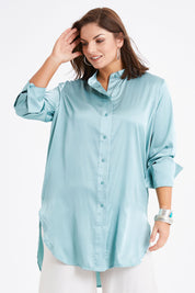 Model Monique wearing size 14 of the Going With The Flow Tunic Blouse in colour Sage (Green), from the front, cropped image