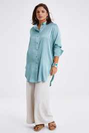 Model Monique wearing size 14 of the Going With The Flow Tunic Blouse in colour Sage (Green), from the front, showing the whole outfit