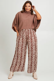 Model Monique wearing size 14 of the Swept Away By You Pant in colour Tribe, from the front, showing the whole outfit