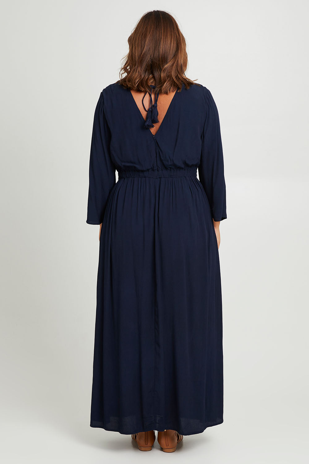 Model Monique wearing size 10 of the One Fine Day Cross Back Maxi in colour Darknavy (Blue), from the back