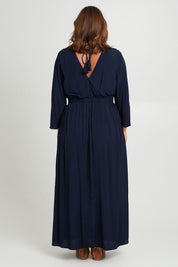 Model Monique wearing size 10 of the One Fine Day Cross Back Maxi in colour Darknavy (Blue), from the back