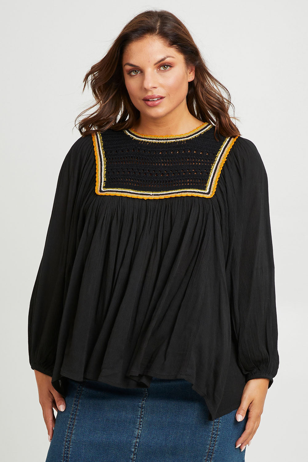 Model Monique wearing size 14 of the Ebb And Flow Crochet Detail Top in colour Black (Black), from the front, cropped image