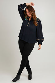 Model Laura wearing size 14 of the Say You Love Me Blouse in colour Black (Black), from the front, showing the whole outfit