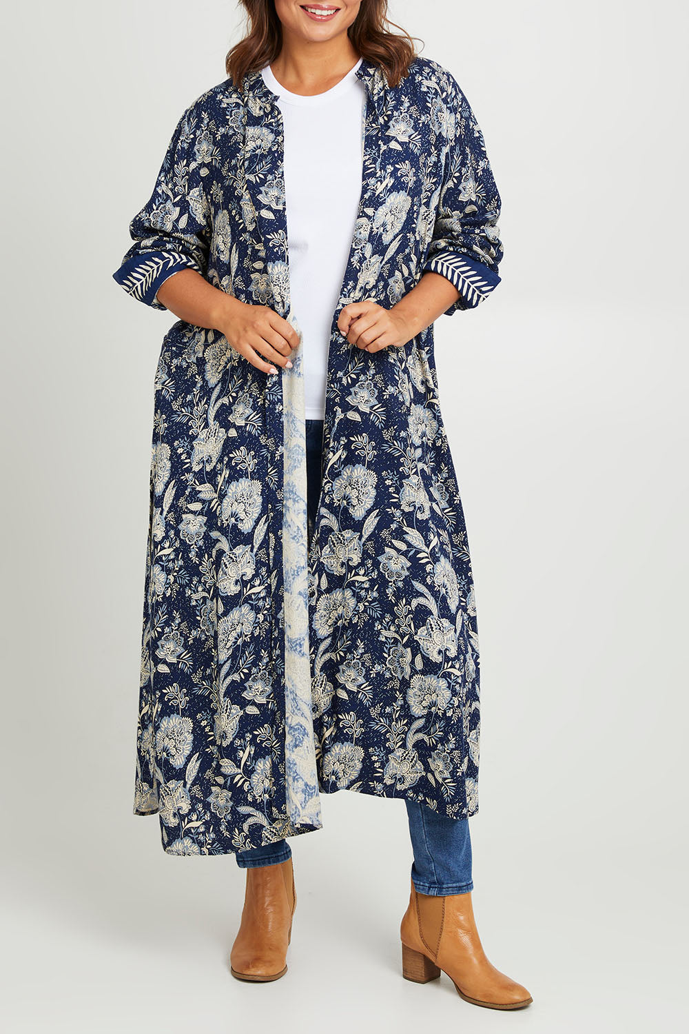 Model Monique wearing size 14 of the Swept Away By You Duster Blouse in colour Bluefleur (Blue), from the front, cropped image