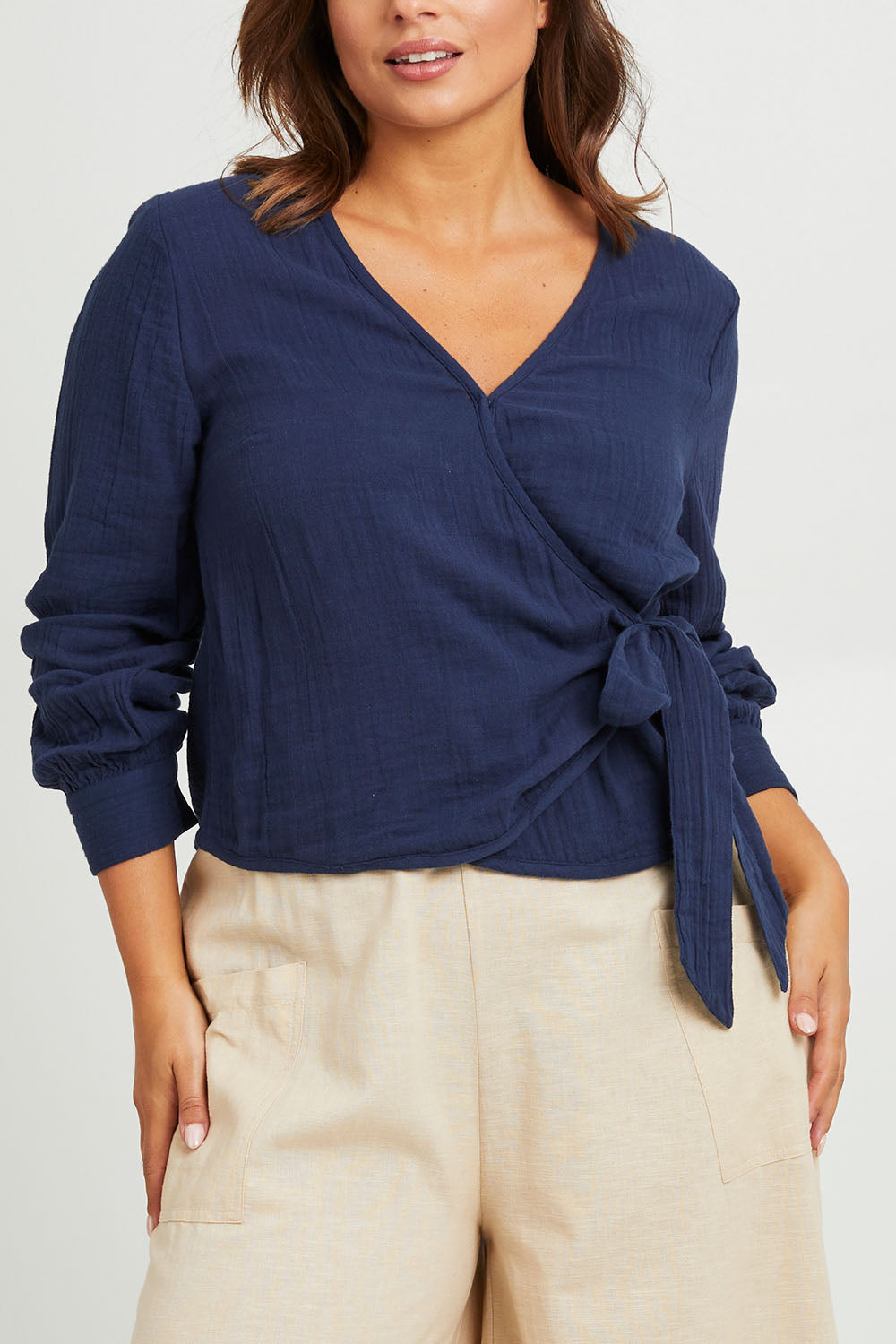 Model Monique wearing size 14 of the Wrapped Up In Your Love Blouse in colour Navy (Blue), from the front, cropped image