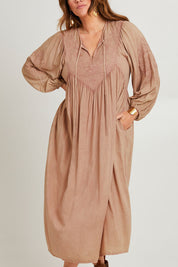 Model Laura wearing size 14 of the Through The Fields Dress in colour Dust, from the front, cropped image