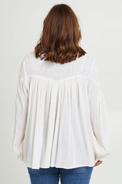 Model Monique wearing size 14 of the Fabulous Flouncy Cotton Blouse in colour Cream (White), from the back