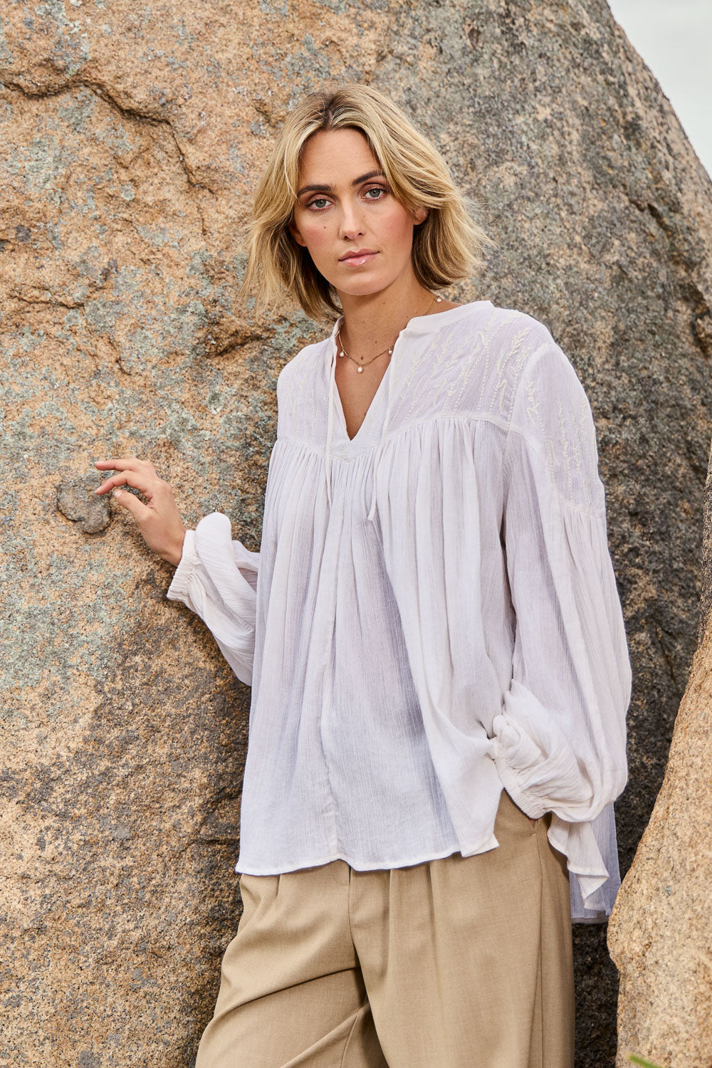 Model Tegan wearing size 10 of the Fabulous Flouncy Cotton Blouse in colour Cream (White), from the front, showing the whole outfit