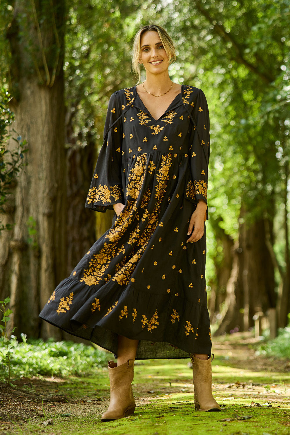 Model Tegan wearing size 10 of the Dancing With Joy Dress in colour Black (Black), from the front, showing the whole outfit
