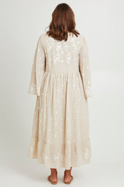 Model Monique wearing size 14 of the Dancing With Joy Dress in colour Latte, from the back