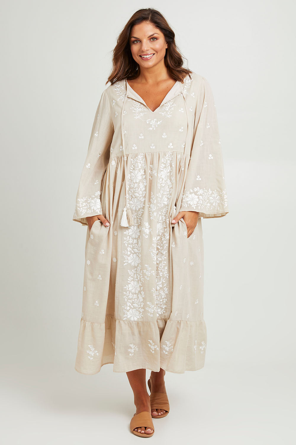 Model Monique wearing size 14 of the Dancing With Joy Dress in colour Latte, from the front, showing the whole outfit