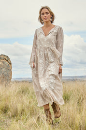 Model Tegan wearing size 10 of the Dancing With Joy Dress in colour Latte, from the front, showing the whole outfit