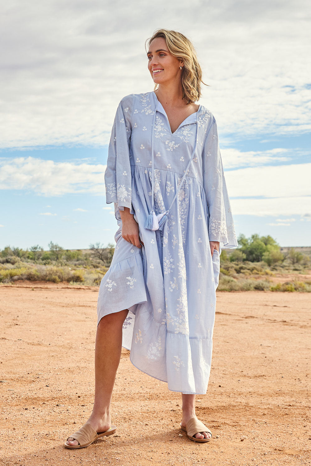 Model Tegan wearing size 10 of the Dancing With Joy Dress in colour Skyblue (Blue), from the front, showing the whole outfit