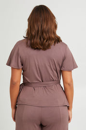 Model Monique wearing size 14 of the All For You Wrap Top in colour Tobacco, from the back