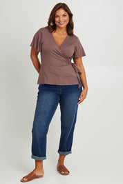 Model Monique wearing size 14 of the All For You Wrap Top in colour Tobacco, from the front, showing the whole outfit