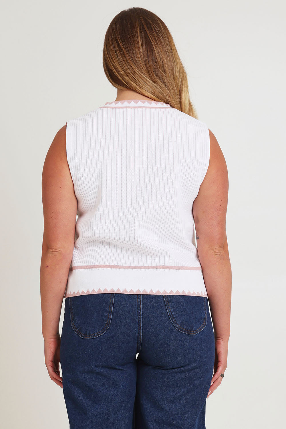 Model Chanel wearing size XL of the Always Classic Knit Tank in colour Milkrose, from the back