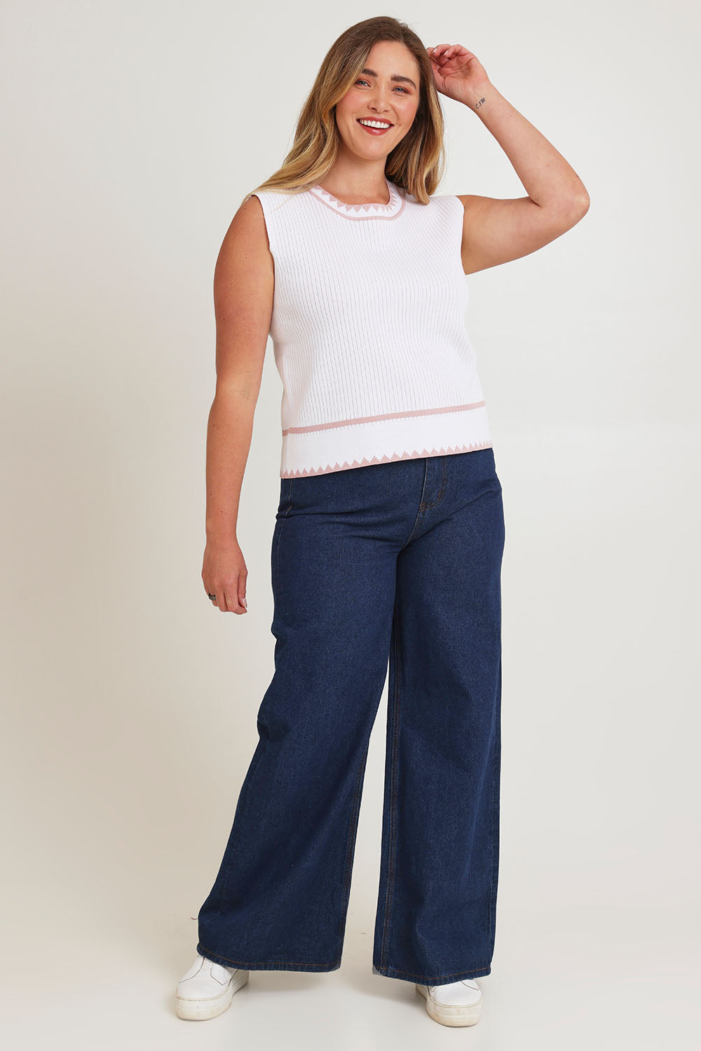 Model Chanel wearing size XL of the Always Classic Knit Tank in colour Milkrose, from the front, showing the whole outfit