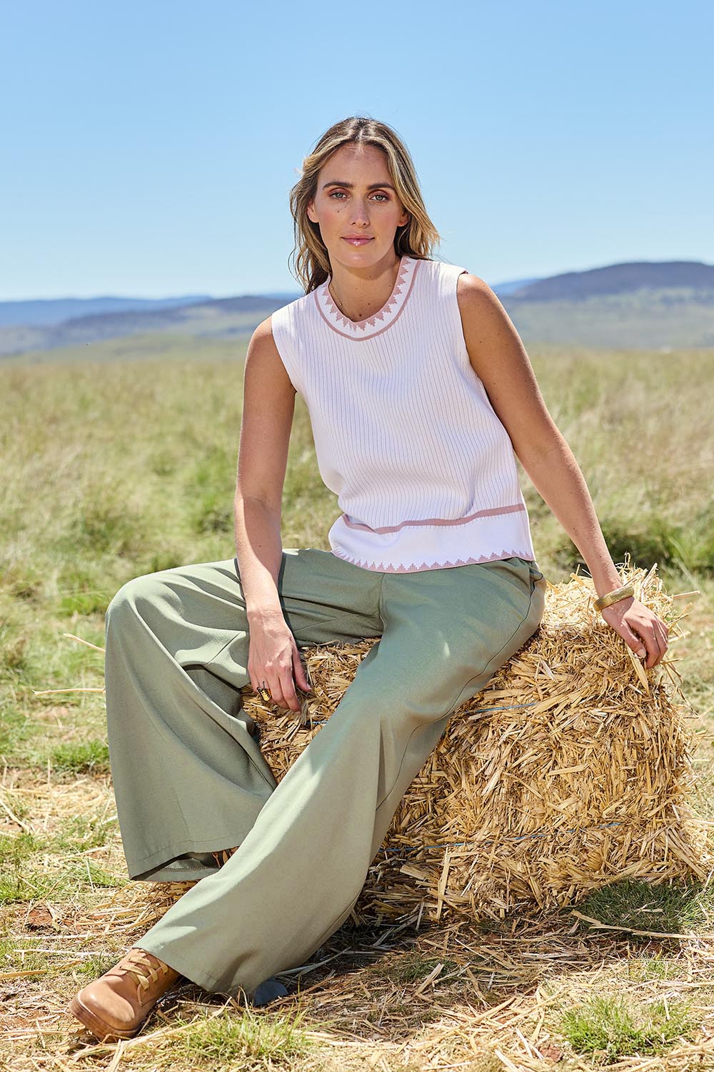Model Tegan wearing size S of the Always Classic Knit Tank in colour Milkrose, from the front, showing the whole outfit