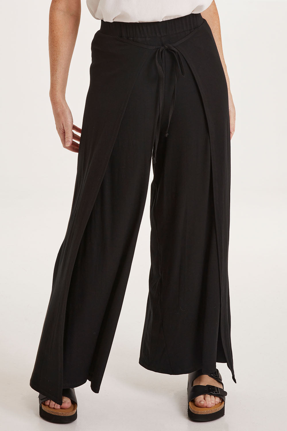 Model Sally wearing size 10 of the All For You Wrap Pants in colour Black (Black), from the front, cropped image