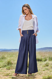 Model Tegan wearing size 10 of the High Flying Wide Leg Chambray Pants in colour Darkdenim (Blue), from the front, showing the whole outfit