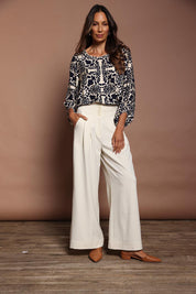Model Amanda wearing size 10 of the High Flying Wide Leg Pants in colour Cream, from the front, showing the whole outfit