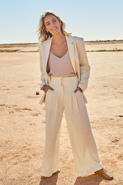 Model Tegan wearing size 10 of the High Flying Wide Leg Pants in colour Cream, from the front, showing the whole outfit