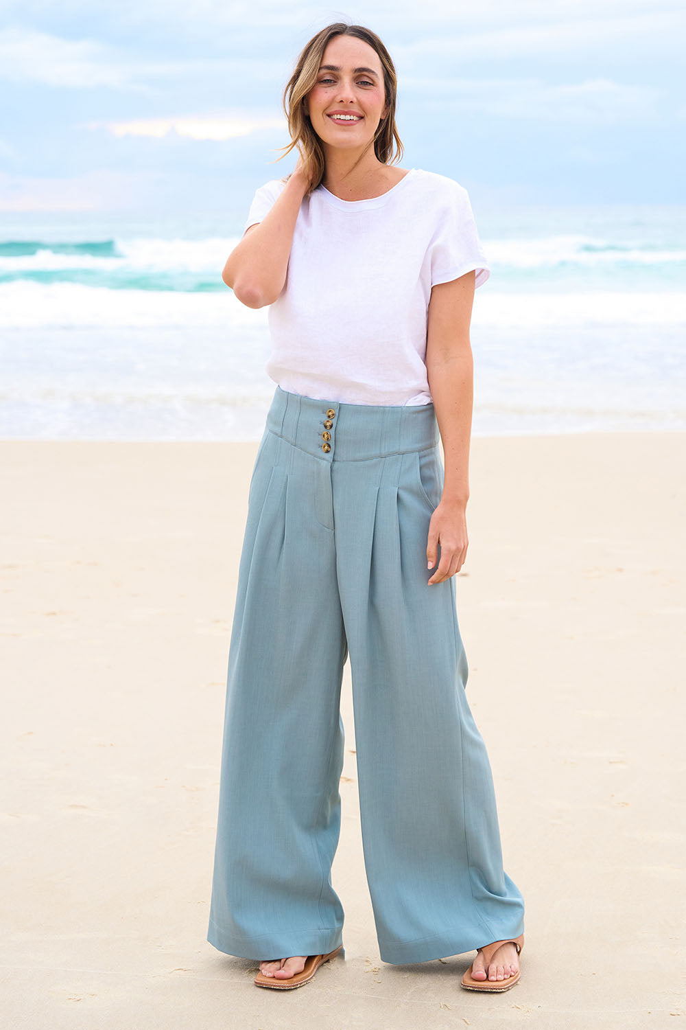 Model Tegan wearing size 10 of the High Flying Wide Leg Pants in colour Dusk (Green), from the front, showing the whole outfit