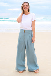 Model Tegan wearing size 10 of the High Flying Wide Leg Pants in colour Dusk (Green), from the front, showing the whole outfit