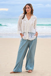 Model Tegan wearing size 10 of the High Flying Wide Leg Pants in colour Dusk (Green), from the front, showing the whole outfit