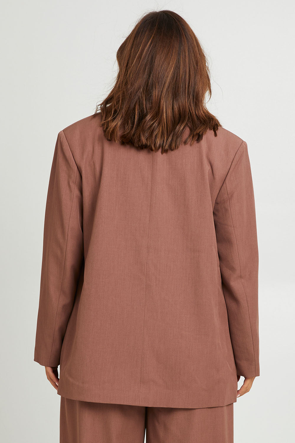 Model Monique wearing size 14 of the High Flying Oversized Blazer in colour Walnut, from the back
