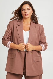 Model Monique wearing size 14 of the High Flying Oversized Blazer in colour Walnut, from the front, cropped image