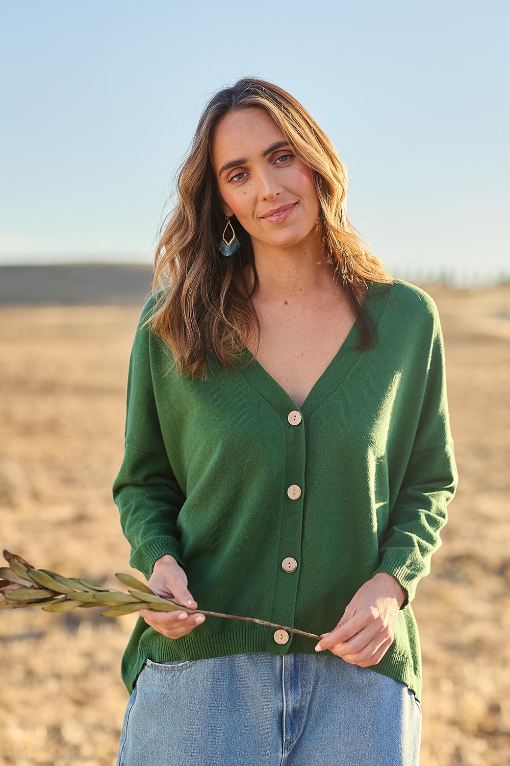 Model Tegan wearing size S of the My Boyfriends Cotton Cashmere Cardi in colour Meadow (Green), from the front, showing the whole outfit