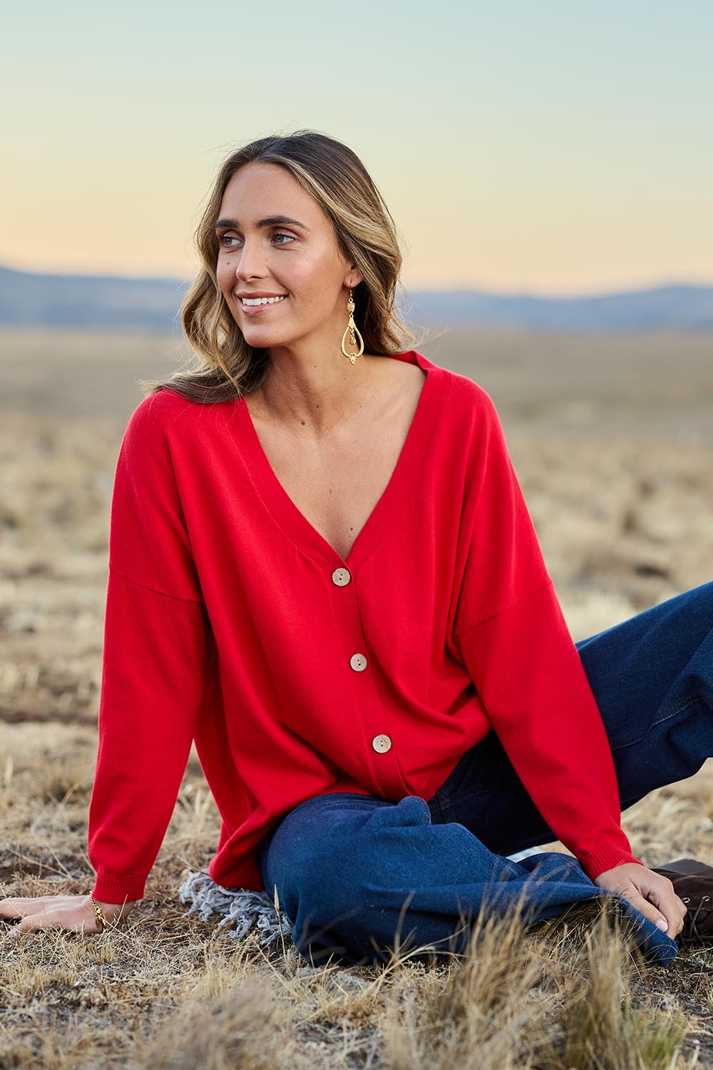 Model Tegan wearing size S of the My Boyfriends Cotton Cashmere Cardi in colour Scarlet (Red), from the front, showing the whole outfit