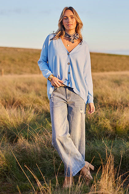 Model Tegan wearing size S of the My Boyfriends Cotton Cashmere Cardi in colour Sky (Blue), from the front, showing the whole outfit