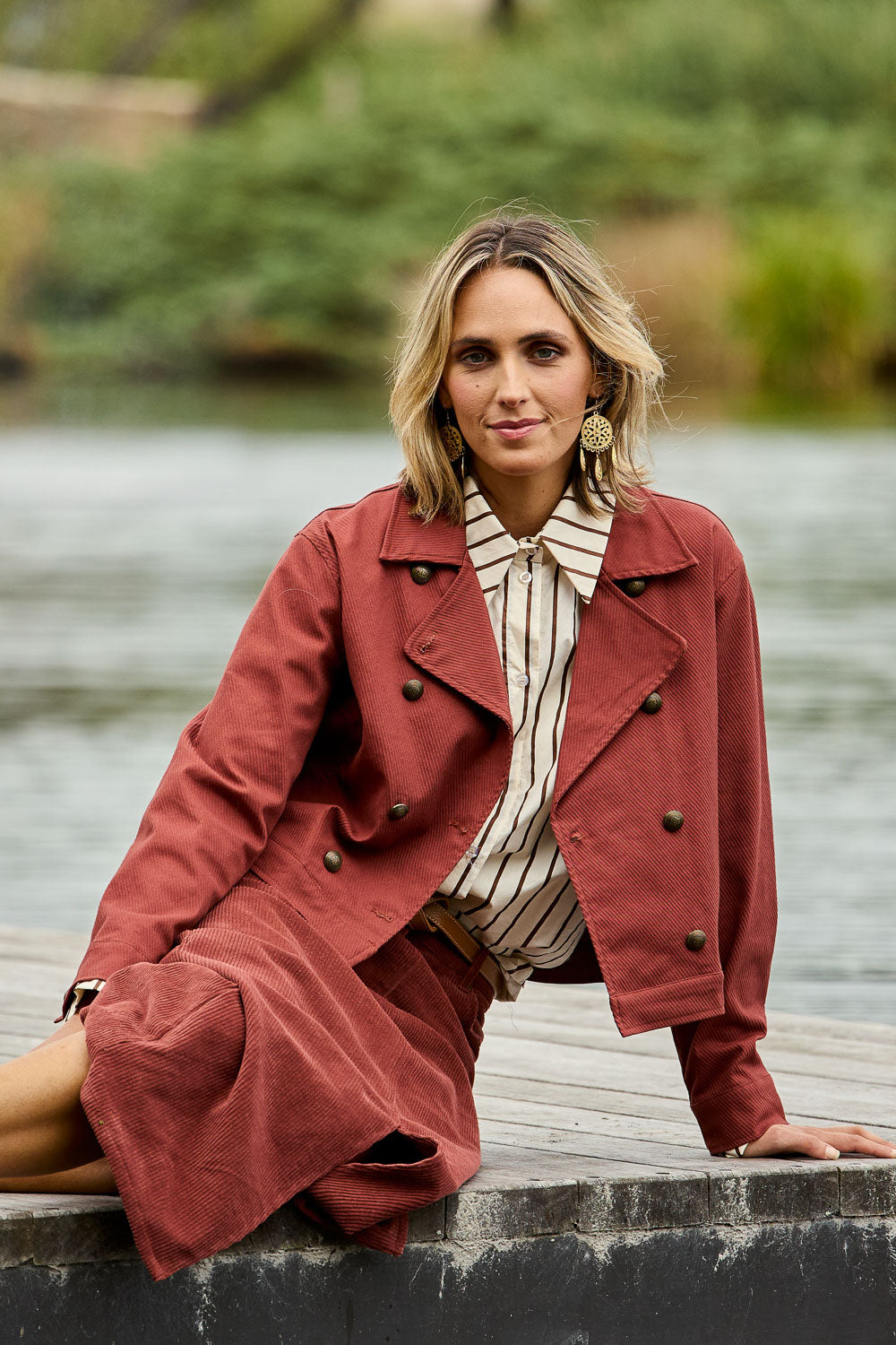 Model Tegan wearing size 10 of the Coffee Date Jacket in colour Rust (Red), from the front, showing the whole outfit