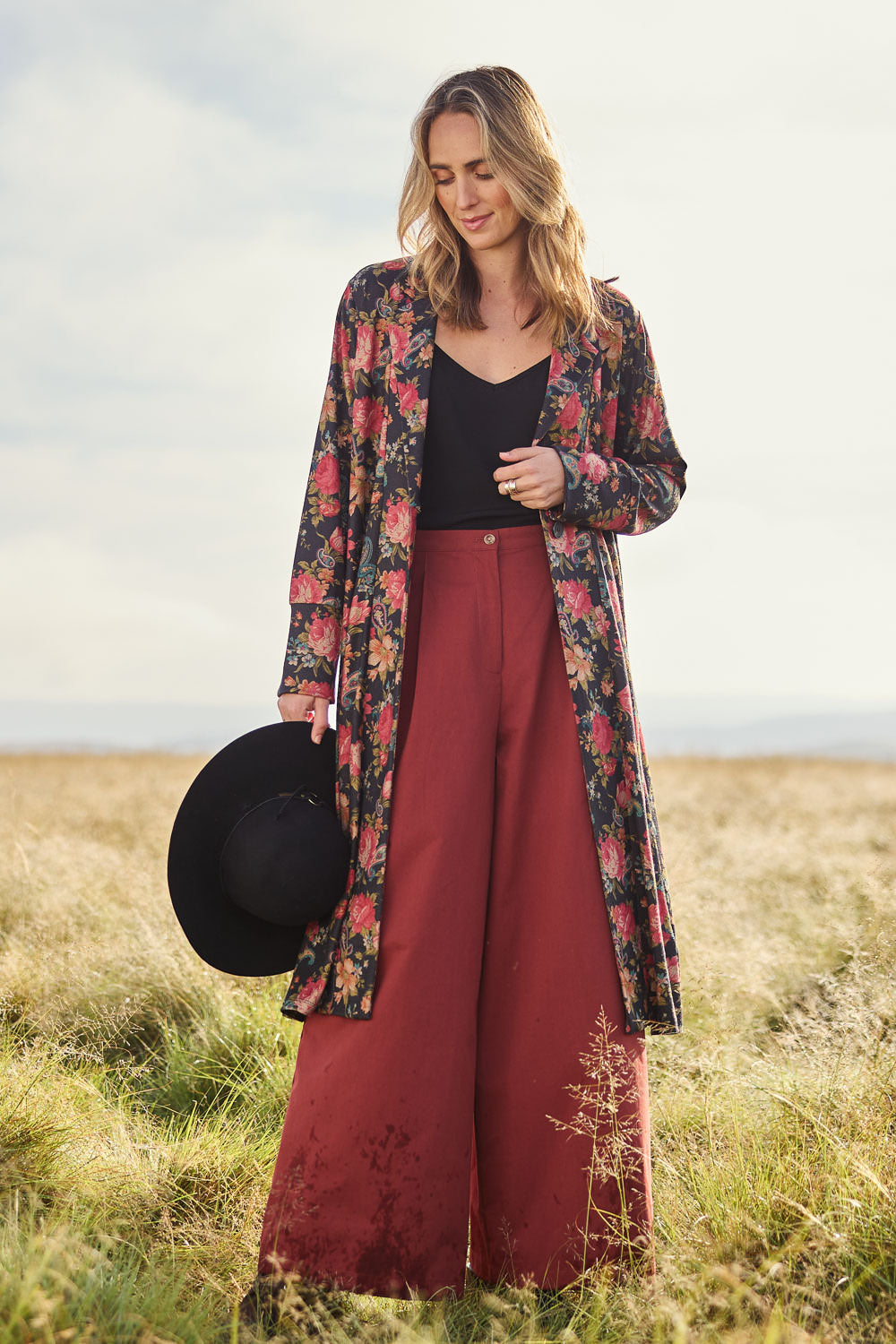 Model Tegan wearing size 10 of the Flowers For Me Cardigan in colour Blackrose (Black), from the front, showing the whole outfit