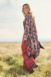 Model Tegan wearing size 10 of the Flowers For Me Cardigan in colour Blackrose (Black), from the front, showing the whole outfit