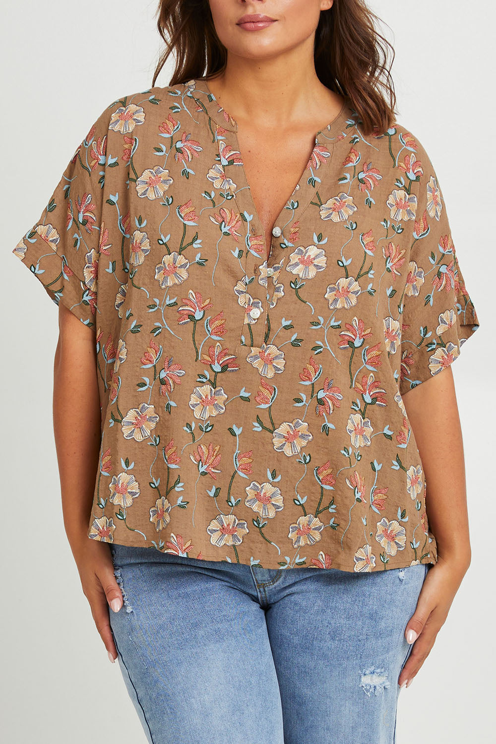 Model Monique wearing size 14 of the Flower Chain Slouch Top in colour Fleur, from the front, cropped image