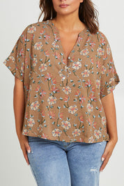 Model Monique wearing size 14 of the Flower Chain Slouch Top in colour Fleur, from the front, cropped image