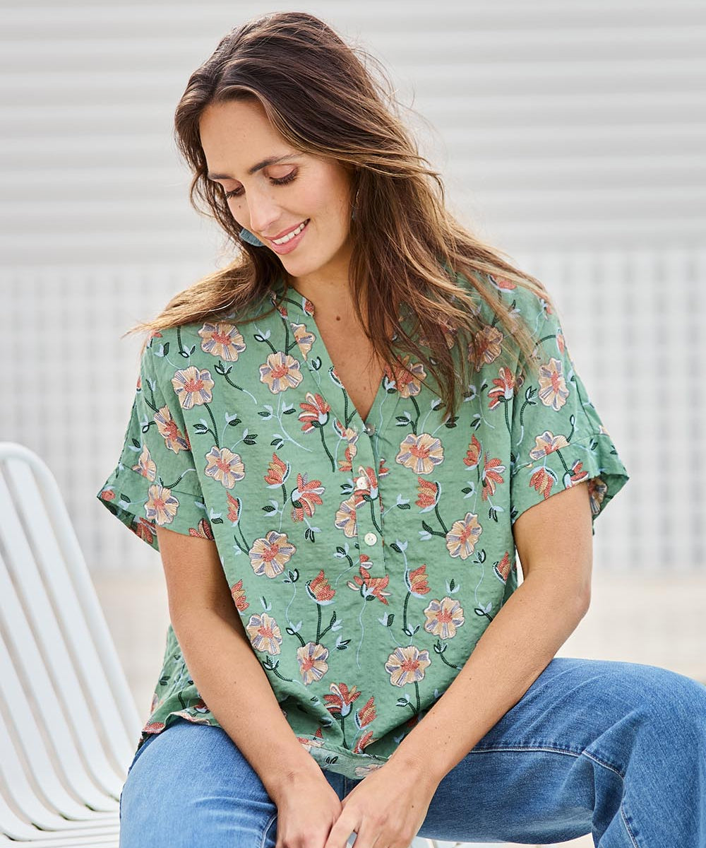 Model Tegand wearing size 10 of the Flower Chain Slouch Top – Leaf in colour Leaf, in a cropped view