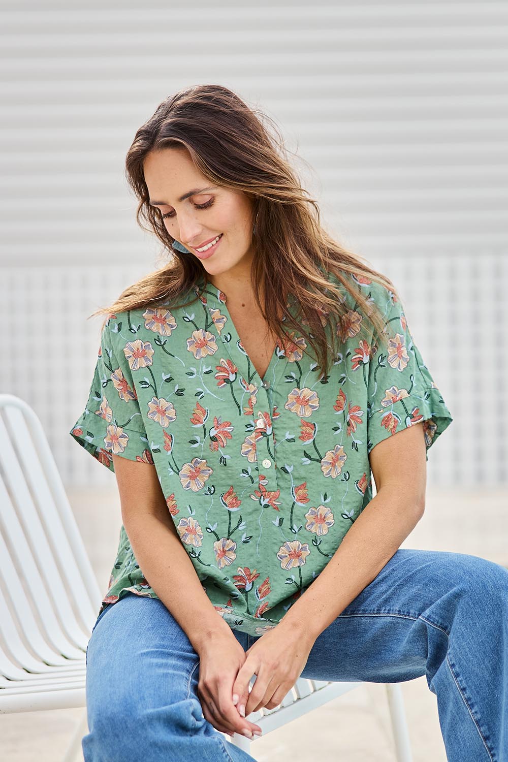 Model Tegand wearing size 10 of the Flower Chain Slouch Top – Leaf in colour Leaf, in a cropped view