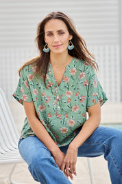 Model Tegand wearing size 10 of the Flower Chain Slouch Top – Leaf in colour Leaf, in a cropped view
