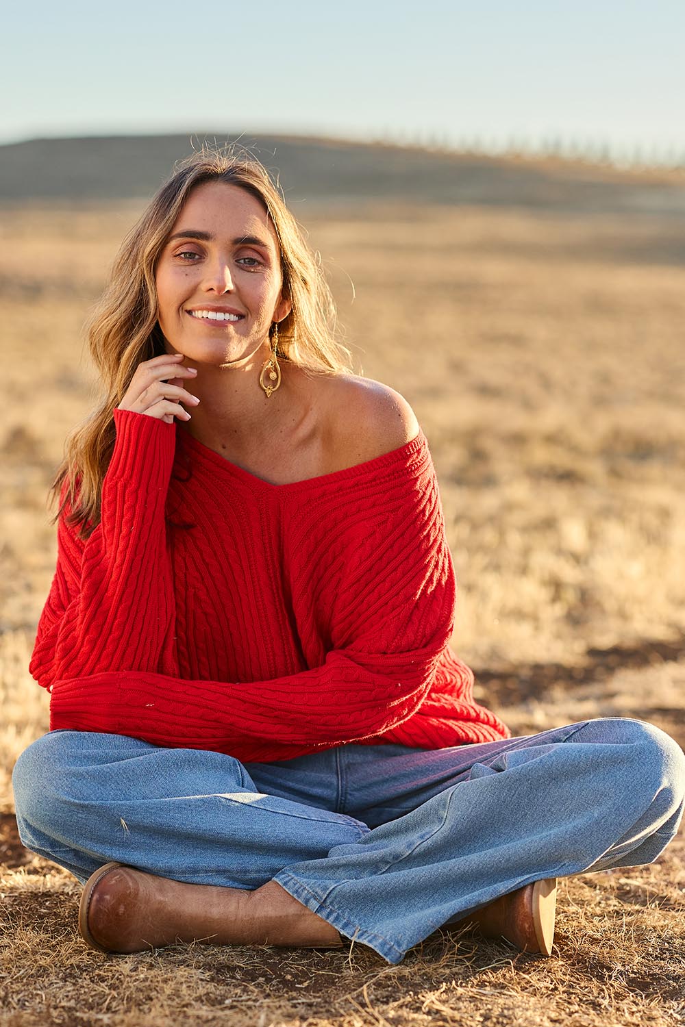 Model Tegan wearing size S of the Ready And Cable Jumper in colour Firecraker (Red), from the front, showing the whole outfit