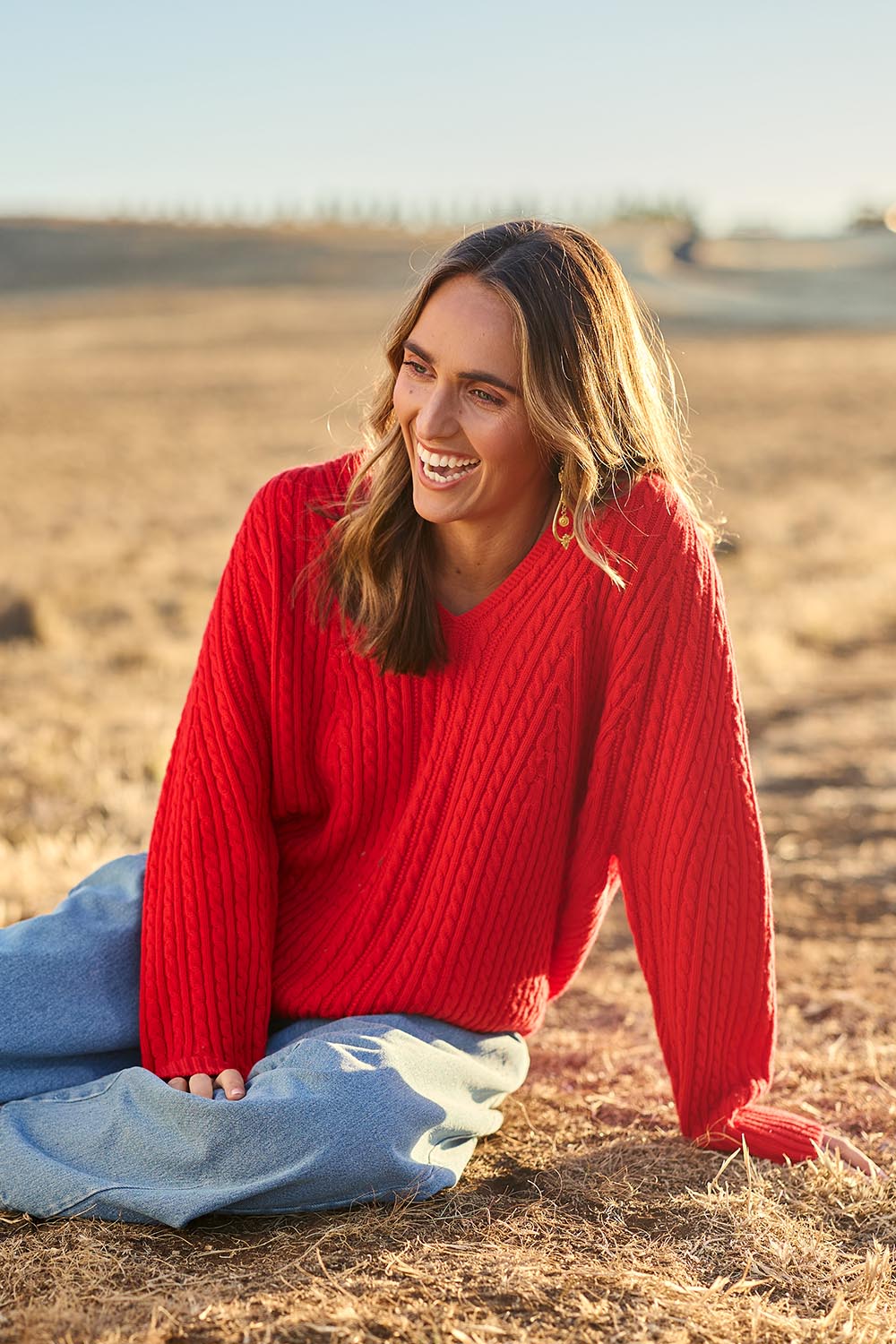 Model Tegan wearing size S of the Ready And Cable Jumper in colour Firecraker (Red), from the front, showing the whole outfit
