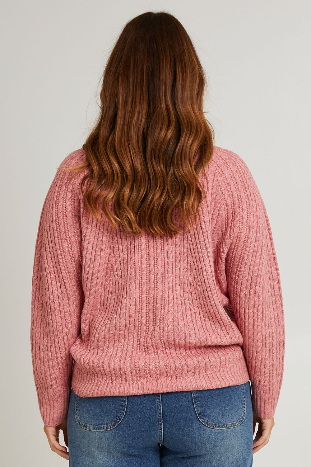 Model Laura wearing size L of the Ready And Cable Jumper in colour Petal (Pink), from the back