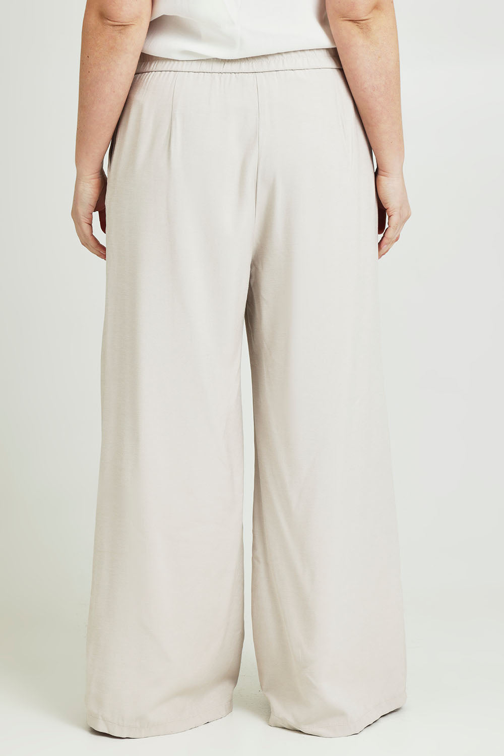 Model Jane wearing size 14 of the Striding Out Wide Leg Pants in colour Moet, from the back